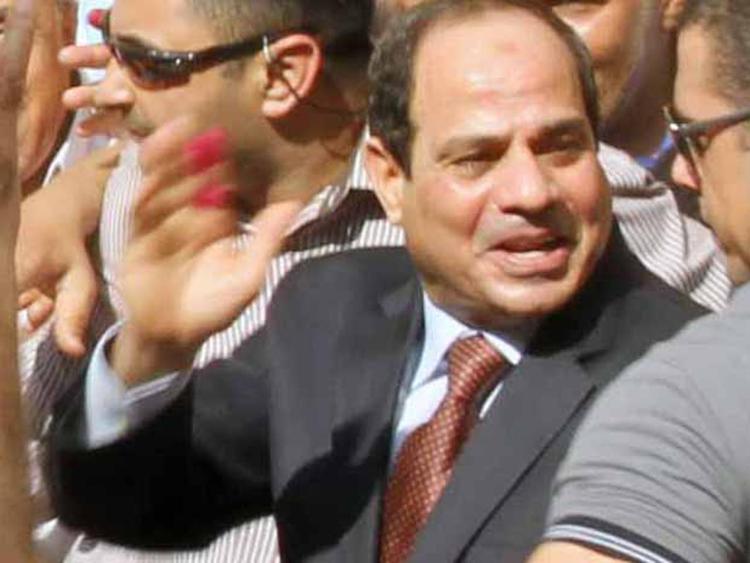 (140526) -- CAIRO, May 26, 2014 (Xinhua) -- Presidential candidate Abdel-Fattah al-Sisi(2nd R) waves to supporters at a polling station in Cairo, Egypt, May 26, 2014. Egyptian voters started casting their ballots on Monday across the country in the first presidential elections following the ouster of former Islamist President Mohamed Morsi. Ex-military chief Abdel-Fattah al-Sisi, who led Morsi's overthrow, and leftist leader Hamdeen Sabahy are the only two contestants in the race. (Xinhua/STR) (djj) - Infophoto - INFOPHOTO