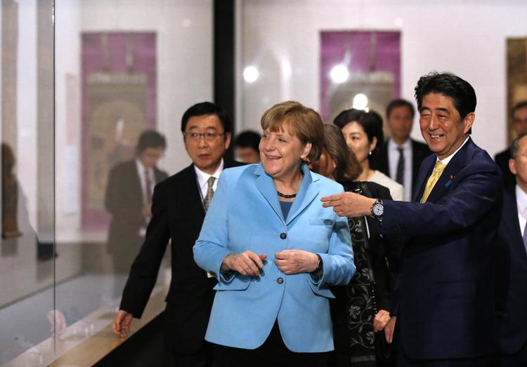 La cancelliera tedesca Angela Merkel e il primo ministro giapponese Shinzo Abe visitano un museo a Tokio.   - (foto AFP)