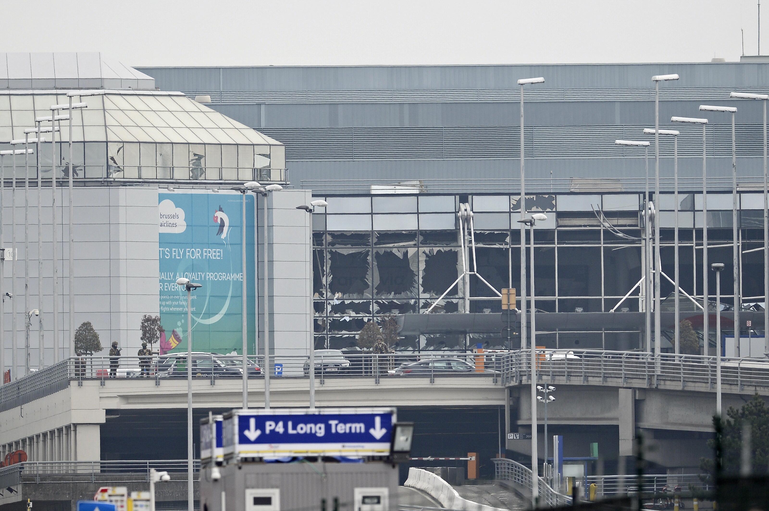 A picture shows damage to the facade of Brussels Airport, in Zaventem, on March 2016 after two explosions in the airport. Belgian firefighters said there were at least 21 dead after "enormous" blasts hit Brussels airport and the city's metro system. / AFP / BELGA / DIRK WAEM / Belgium OUT