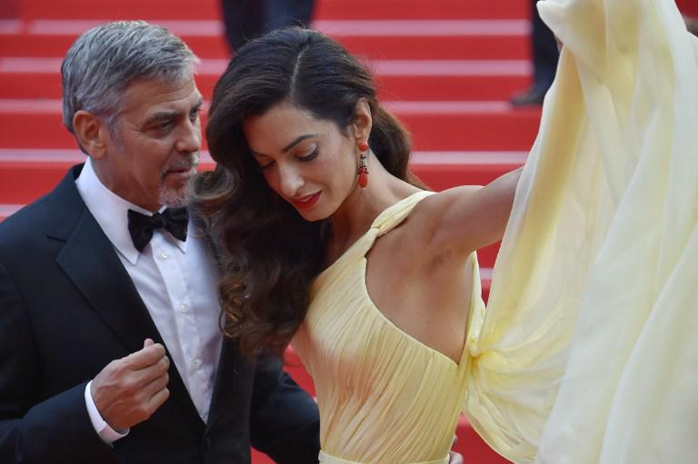George Clooney e sua moglie Amal AFP PHOTO / LOIC VENANCE