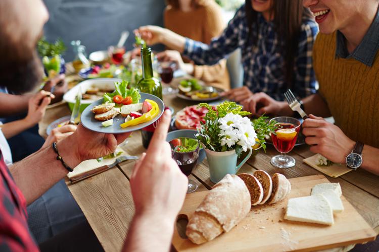 Close-up of friends talking by festive table - pressmaster - Fotolia