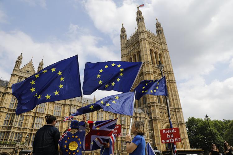 Anti-Brexit protesters demonstrate with placards and EU flags against Britain's exit from the European Union outside the Houses of Parliament in London on 4 July  - Photo: AFP