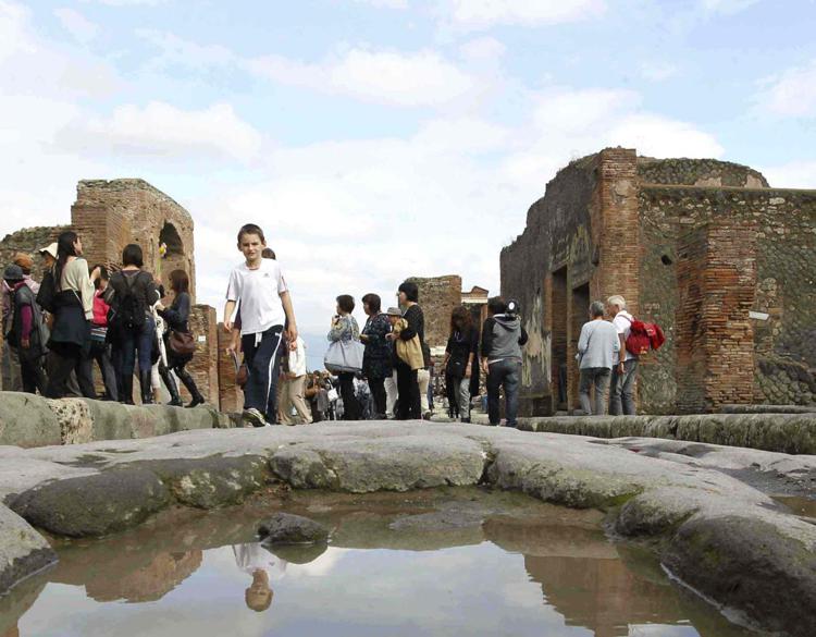 Turisti visitano gli scavi di Pompei (Foto Infophoto)