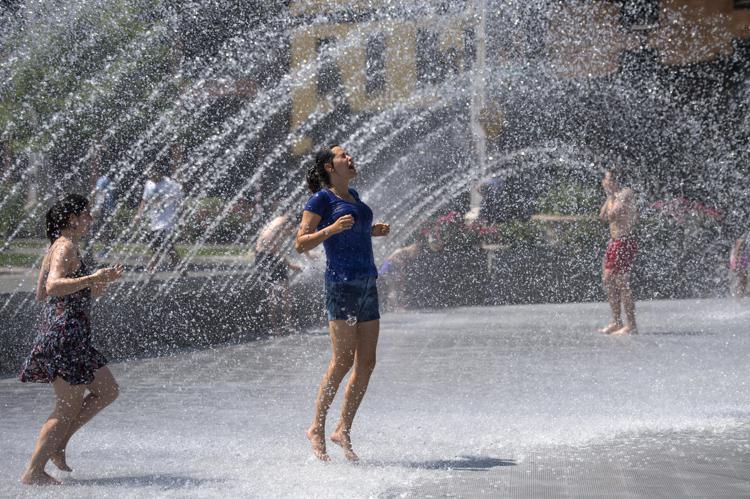 People cool off in a fountain at the Georgetown Waterfront Park as temperatures top out in the mid 90's for the second day in a row, in Washington, D.C. on June 12, 2015. The Nation's Capital is in the middle of a mini heatwave as summer temperatures are expected to stay high though the weekend. Photo by Kevin Dietsch/UPI - Infophoto - INFOPHOTO