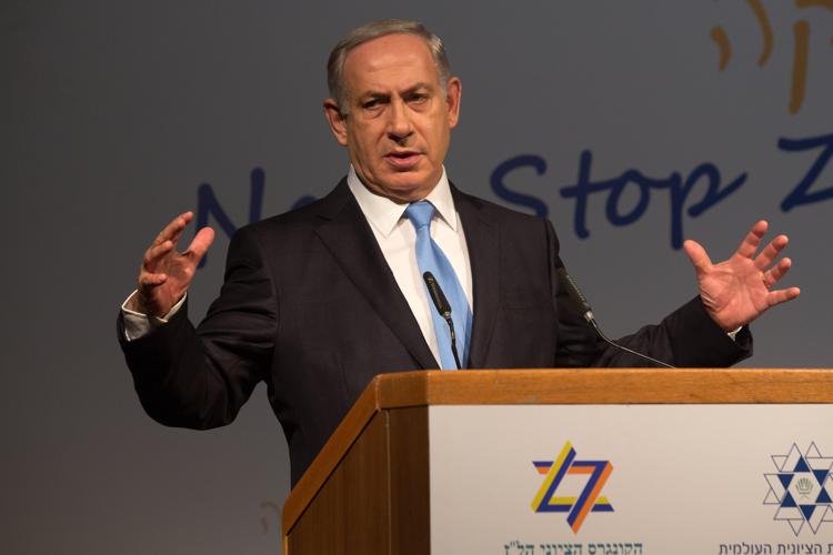 Il premier israeliano  Benjamin Netanyahu nel suo intervento al Congresso sionista a Gerusalemme (Foto Afp)