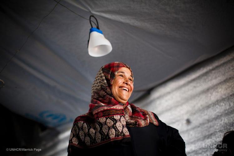 Syrian refugee, Emtyaz smiles as UNHCR staff visit her family's shelter in Azraq Refugee Camp, Al Azraq, Jordan.