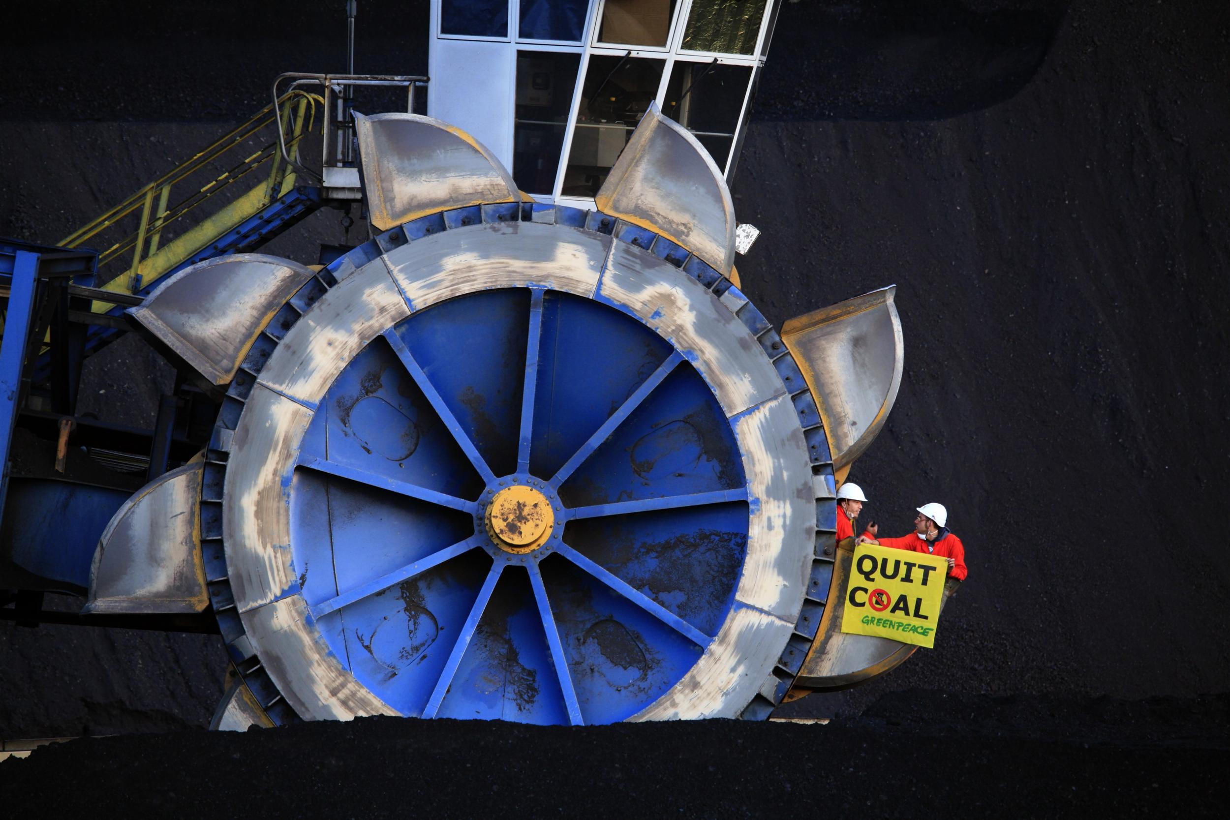 Greenpeace activists block the coal supply to the Fiume Santo power plant of E.ON by locking on to the coal conveyors. They hold a sign reading 'Quit Coal'. The action is to protest against the Sardinian authorities and energy company E.ONs expansion of coal power on the island and rejection of climate saving alternatives.
