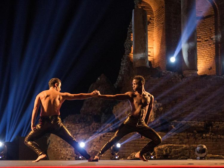 Sulla destra, sul palco del Teatro Greco di Taormina, Moussà Kouyatè, profugo 'salvato' dalla danza 