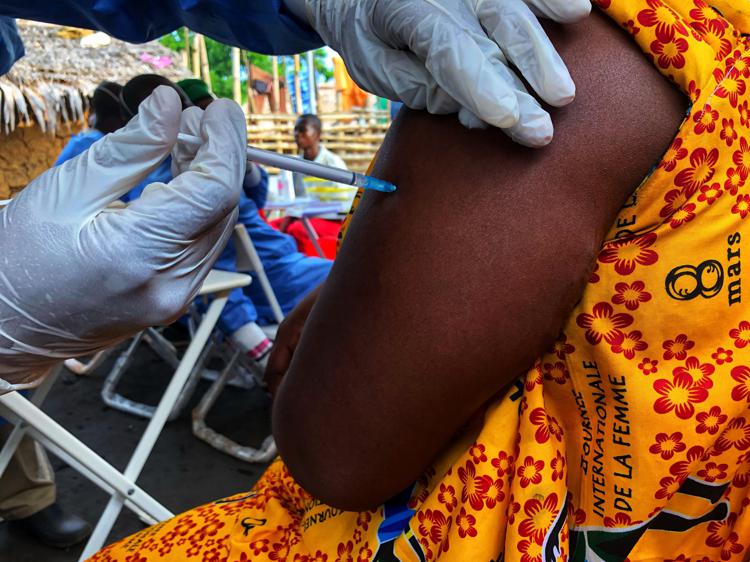 A woman receives an experimental Ebola vaccine at a makeshift clinic on the outskirts of the Congolese city of Mbandaka in early June 2018. MUST CREDIT: Washington Post photo by Max Bearak. - The Washington Post