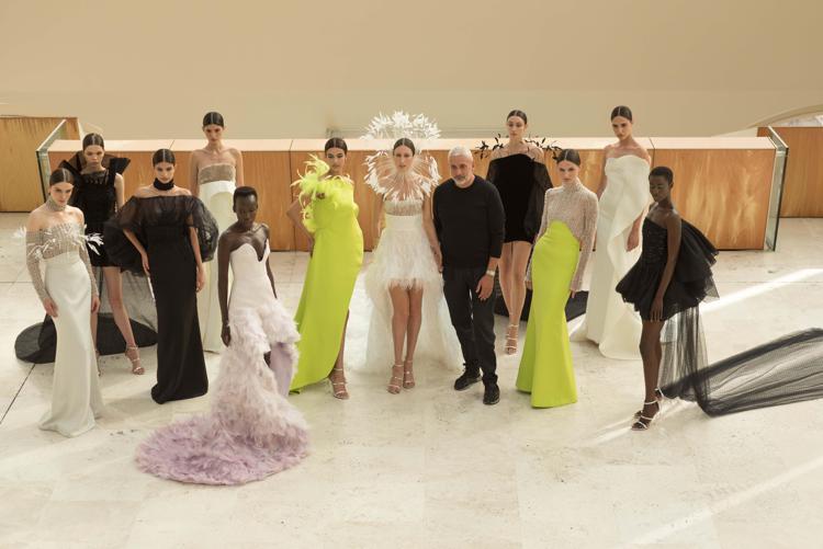 Antonio Grimaldi accanto alle sue   mannequin con gli abiti della collezione haute couture A/I 2021-2022