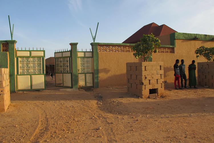 Three teen migrants stand outside a compound in Agadez, Niger on December 5, 2017. MUST CREDIT: Washington Post photo by Sudarsan Raghavan - The Washington Post