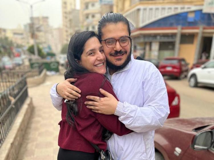 Patrick Zaki (R) hugs his mother on his release in Mansoura