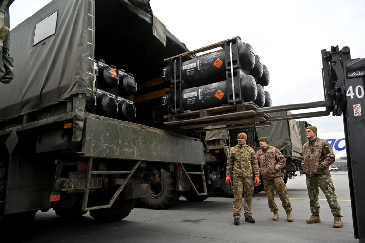 Ukrainian servicemen load a truck with the FGM-148 Javelin, American man-portable anti-tank missile provided by US to Ukraine as part of a military support, upon its delivery at Kyiv's airport Boryspil on February 11,2022, amid the crisis linked with the threat of Russia's invasion. (Photo by Sergei SUPINSKY / AFP)