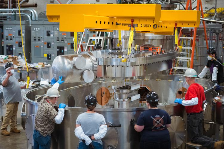A team of engineers and scientists from CFS and MIT’s PSFC lower the superconductingmagnet into the test stand in which the magnet was cooled and powered to produce a magnetic field of 20 tesla - Credit: Gretchen Ertl, CFS/MIT-PSFC, 2021