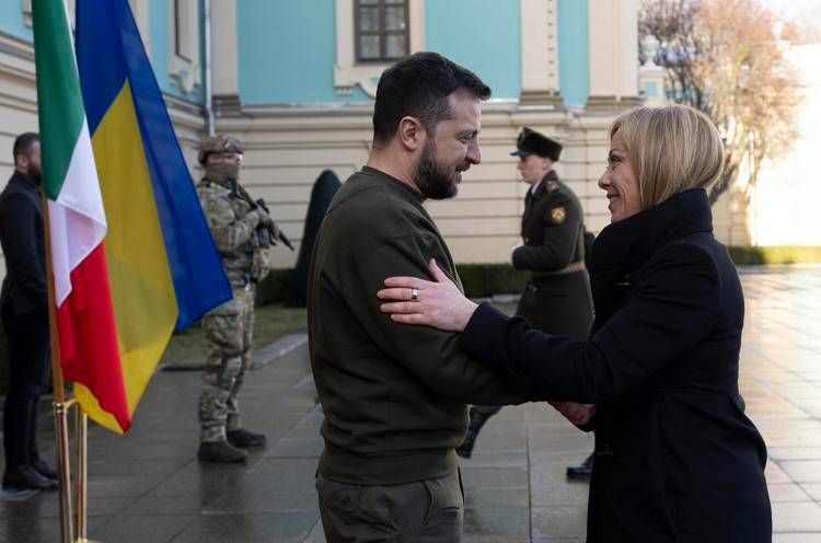 Italy's premier Giorgia Meloni (R) greets Ukraine's president Volodymyr Zelensky (R) in Kiev on 21 February 2023