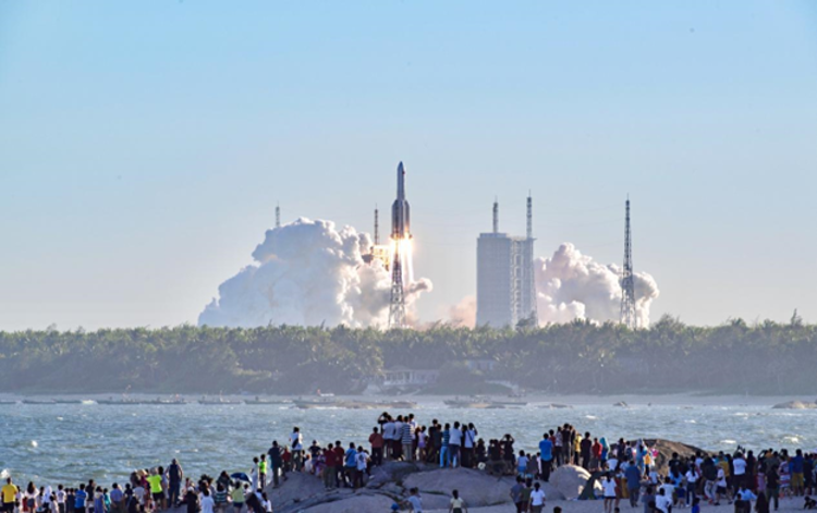 Tourists watch a rocket launch at Qishui Bay, Longlou Town, Wenchang