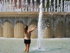 Una donna si rinfresca con l'acqua di una fontana - Ipa