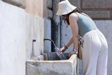 Una turista cerca refrigerio dal caldo torrido a Piazza del Popolo, Roma - Fotogramma / Ipa