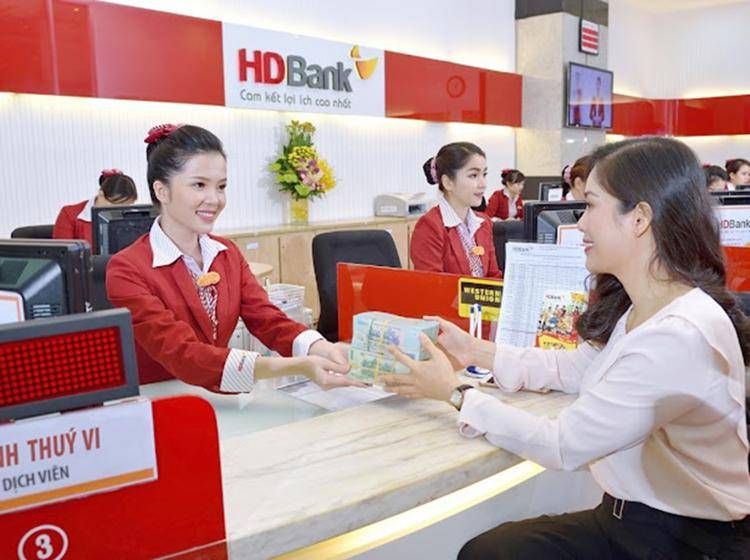 Customers conduct transactions at an HDBank branch in HCM City.