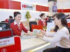 Customers conduct transactions at an HDBank branch in HCM City.