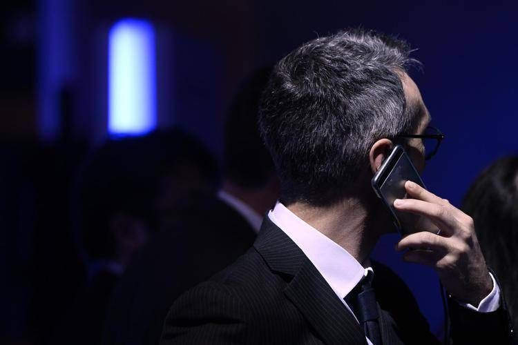 A man uses his smartphone at the Mobile World Congress (MWC), the world's biggest mobile fair, on February 26, 2018 in Barcelona. The Mobile World Congress is held in Barcelona from February 26 to March 1.  / AFP PHOTO / Josep LAGO - AFP