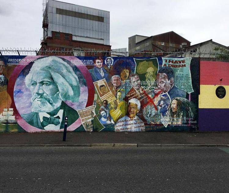 Frederick Douglass, Nelson Mandela and other resistance figures highlight a peace wall off Falls Road in Belfast. Notably, Myanmar's Aung San Suu Kyi has been crossed out to protest persecution of the Rohingya in the country. MUST CREDIT: Photo by Hugh Biggar for The Washington Post. - For The Washington Post