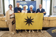 (Il vertice della Fondazione Pordenonelegge.it con la bandiera - Ufficio stampa del Festival)